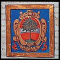 Historisches Wappen des Gerichts Dornbirn mit dem Österreichischen Bindenschild im Hintergrund und dem zentralen Element, dem Birnbaum. Das ganze auf sattblauem Grund, der von einem golden Zierrahmen umgeben ist. Der Birnbaum wurde von den Herdalikern in Wien aus Unwissenheit der Bedeutung des Wortes „Dornbirn“ bzw. „Torrinpuirron“ (Haus bzw. Höfe des Torro) ausgewählt.